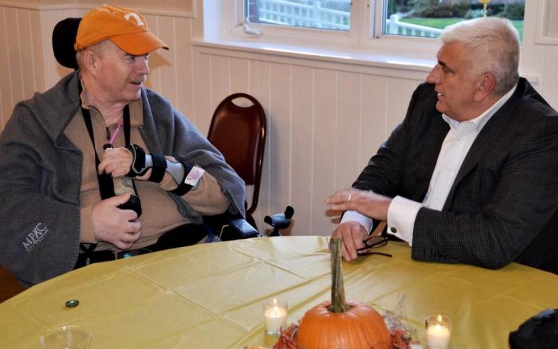 Mayoral candidate Rob Catalanello listens, responds to a wheelchair-bound voter